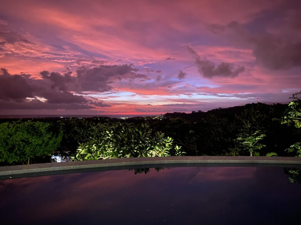 Pink and purple sunset over the infinity pool at Pacific Kalokairi in Tamarindo, Costa Rica
