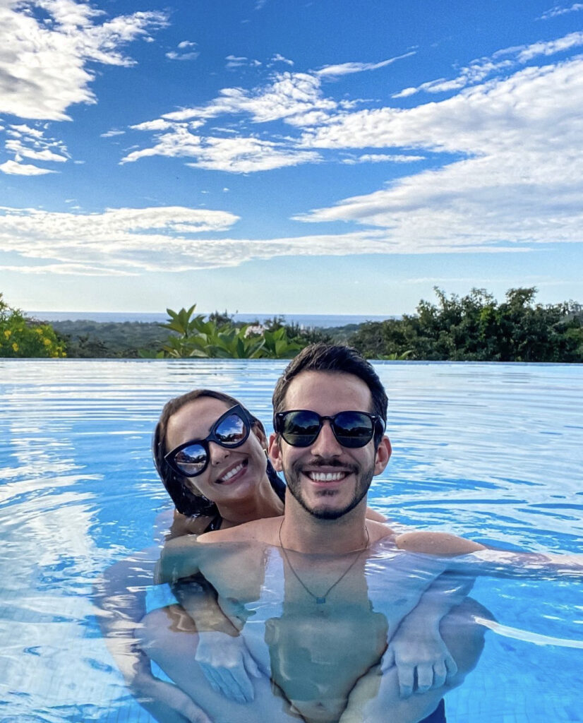 Couple enjoying the infinity pool and ocean views at Pacific Kalokairi adults-only hotel in Tamarindo