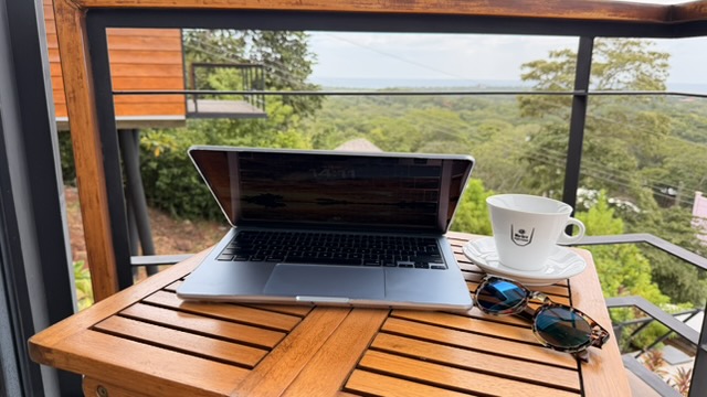 Laptop on a private terrace at Pacific Kalokairi overlooking the tropical landscape in Tamarindo, Costa Rica.