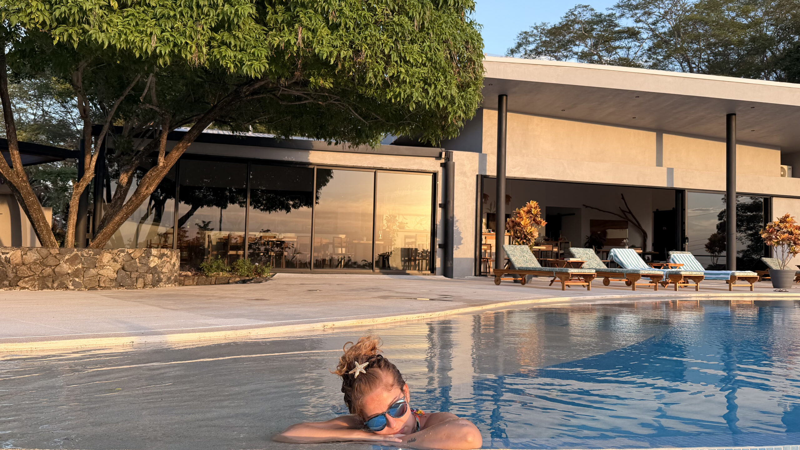 Guest relaxing in the saltwater infinity pool at Pacific Kalokairi in Tamarindo, Costa Rica.
