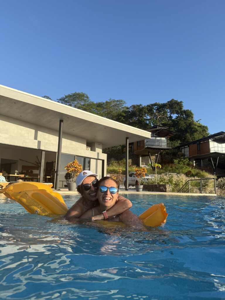 Guests enjoying a relaxed afternoon in the infinity pool at Pacific Kalokairi in Tamarindo.