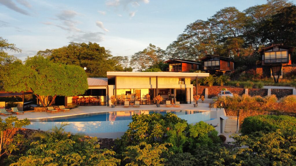 Aerial view of Pacific Kalokairi in Tamarindo, Costa Rica, showing the boutique hotel, infinity pool and private villas surrounded by tropical nature.