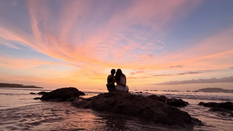 Couple enjoying sunset on Tamarindo Beach, Costa Rica